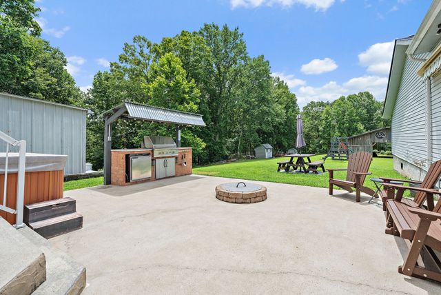 a backyard of a house with plants and large trees
