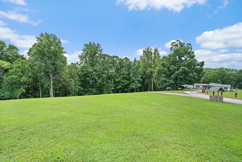 a view of a porch with wooden floor and outdoor seating