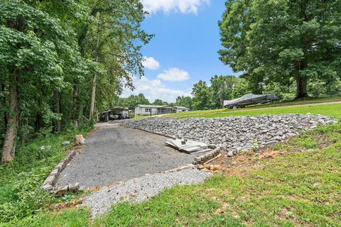 a living room with furniture and a view of kitchen