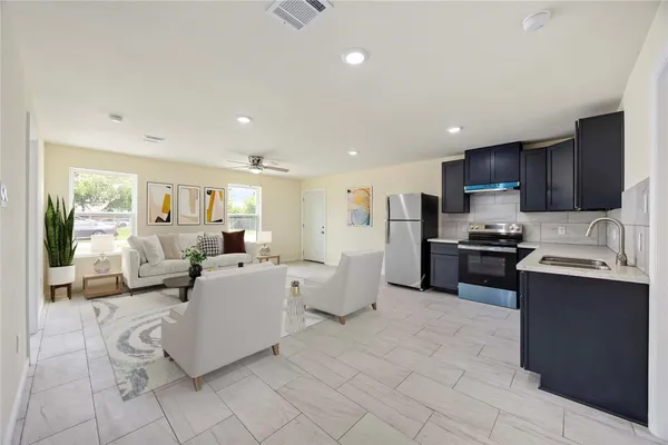 a large white kitchen with lots of appliances and cabinets