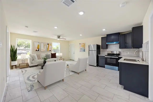 a large white kitchen with lots of appliances and cabinets