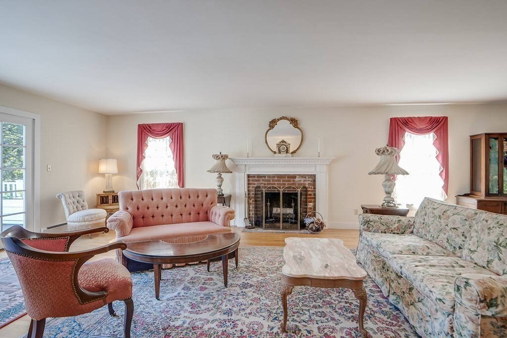 163 Still River Road Harvard, MA 01451 - Photo 12 of 42 a living room with furniture a rug and a fireplace