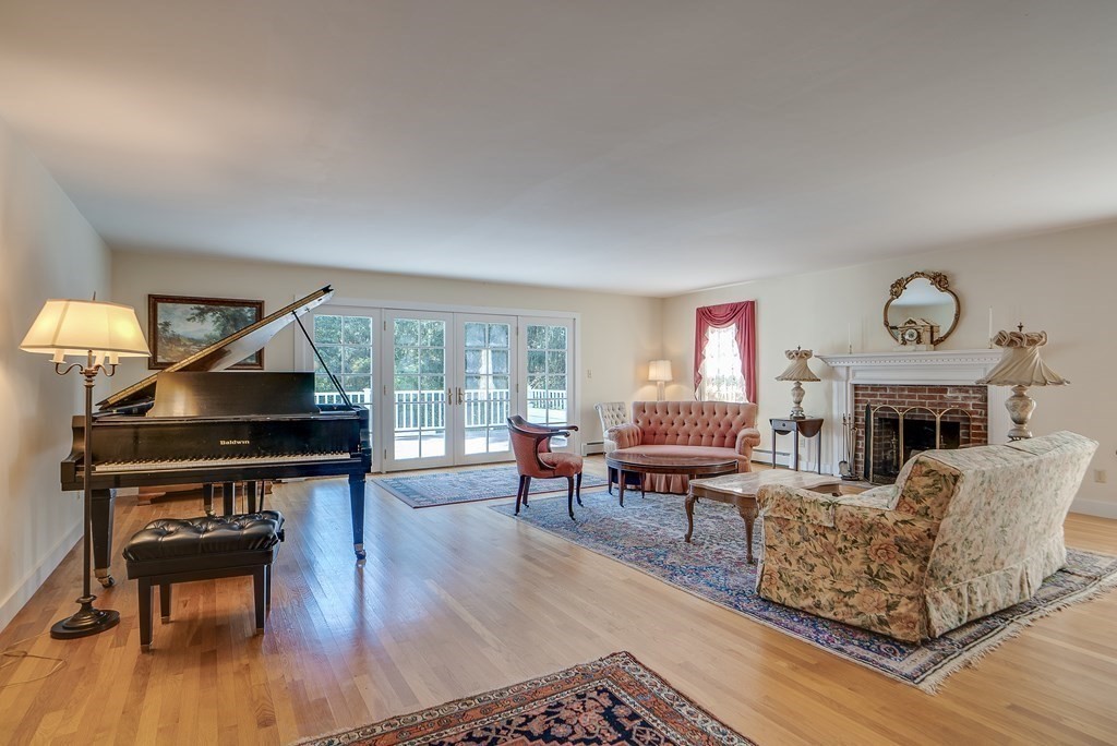 163 Still River Road Harvard, MA 01451 - Photo 13 of 42 a living room with furniture and a fireplace