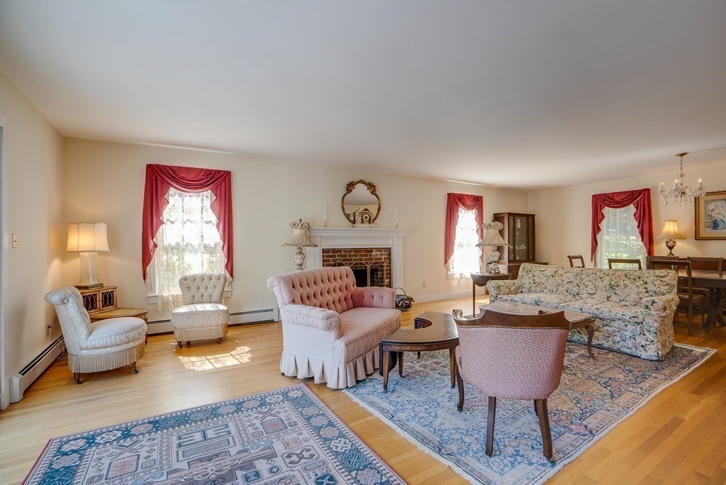 163 Still River Road Harvard, MA 01451 - Photo 15 of 42 a living room with furniture a rug and a chandelier