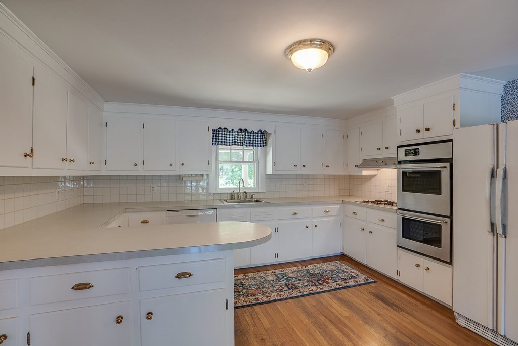 163 Still River Road Harvard, MA 01451 - Photo 19 of 42 a kitchen with a sink stove and cabinets