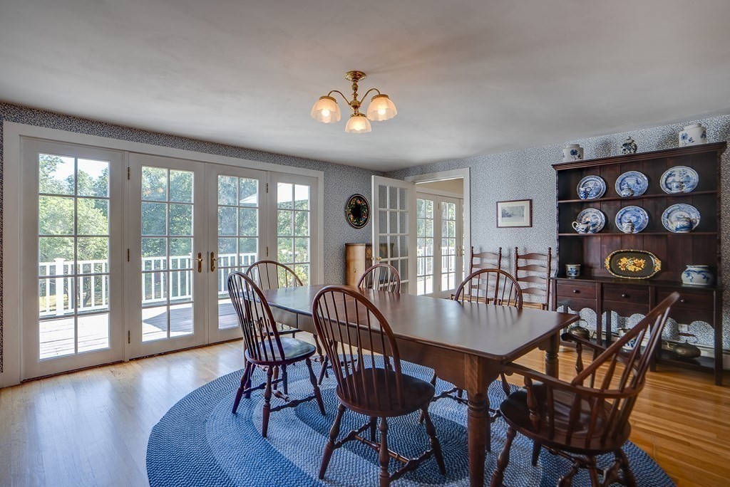 163 Still River Road Harvard, MA 01451 - Photo 22 of 42 a view of a dining room with furniture wooden floor and chandelier