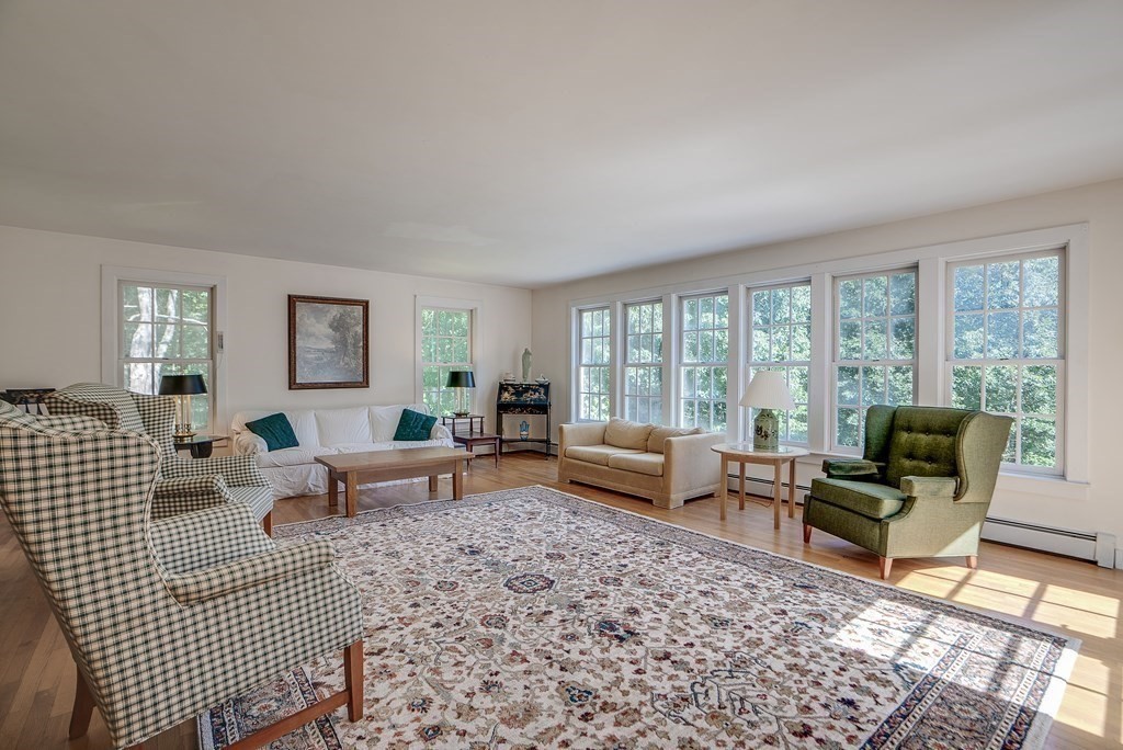 163 Still River Road Harvard, MA 01451 - Photo 23 of 42 a living room with furniture floor to ceiling window and a rug