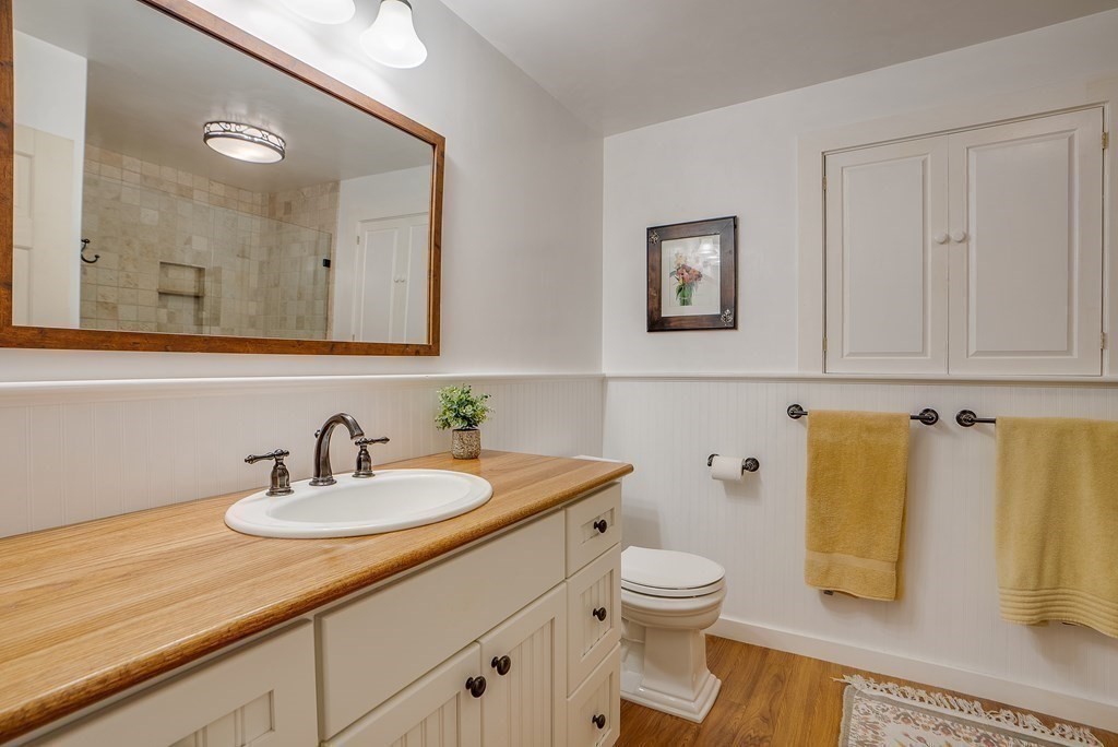 163 Still River Road Harvard, MA 01451 - Photo 35 of 42 a bathroom with a sink a toilet and mirror