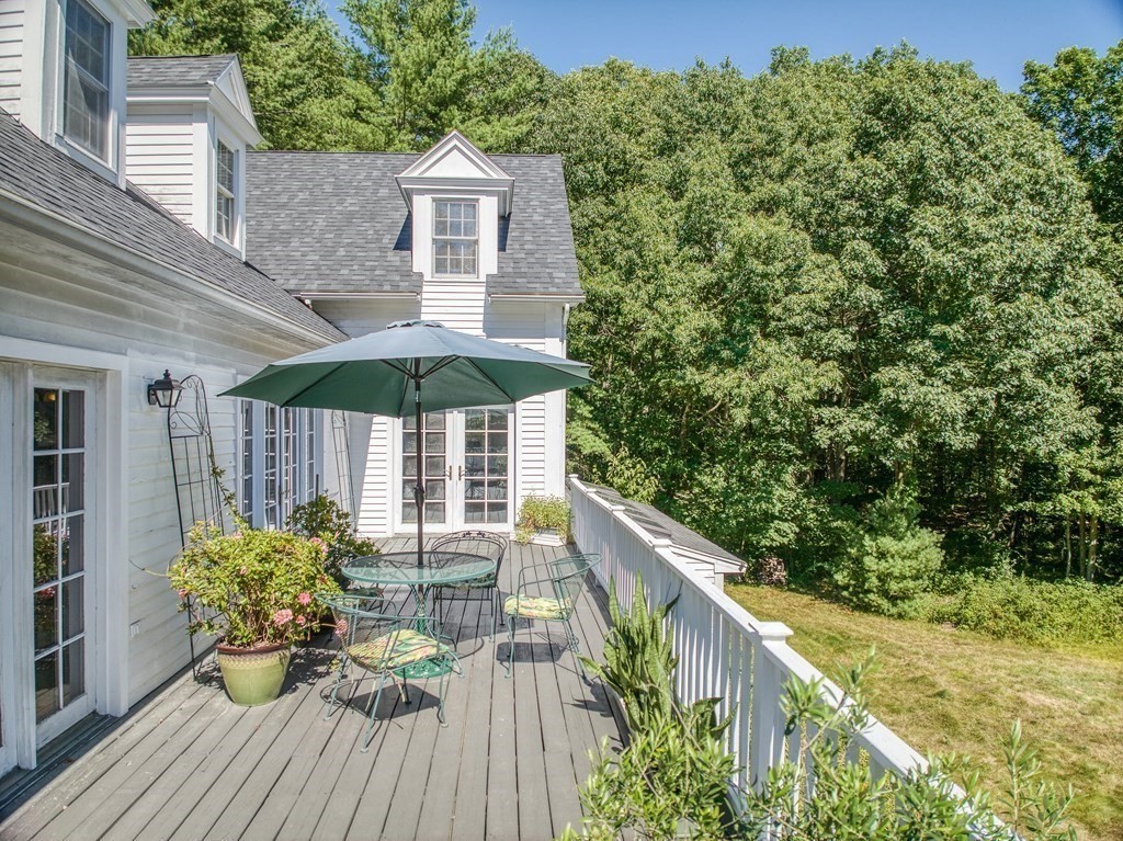 163 Still River Road Harvard, MA 01451 - Photo 4 of 42 a balcony with wooden floor table and chairs