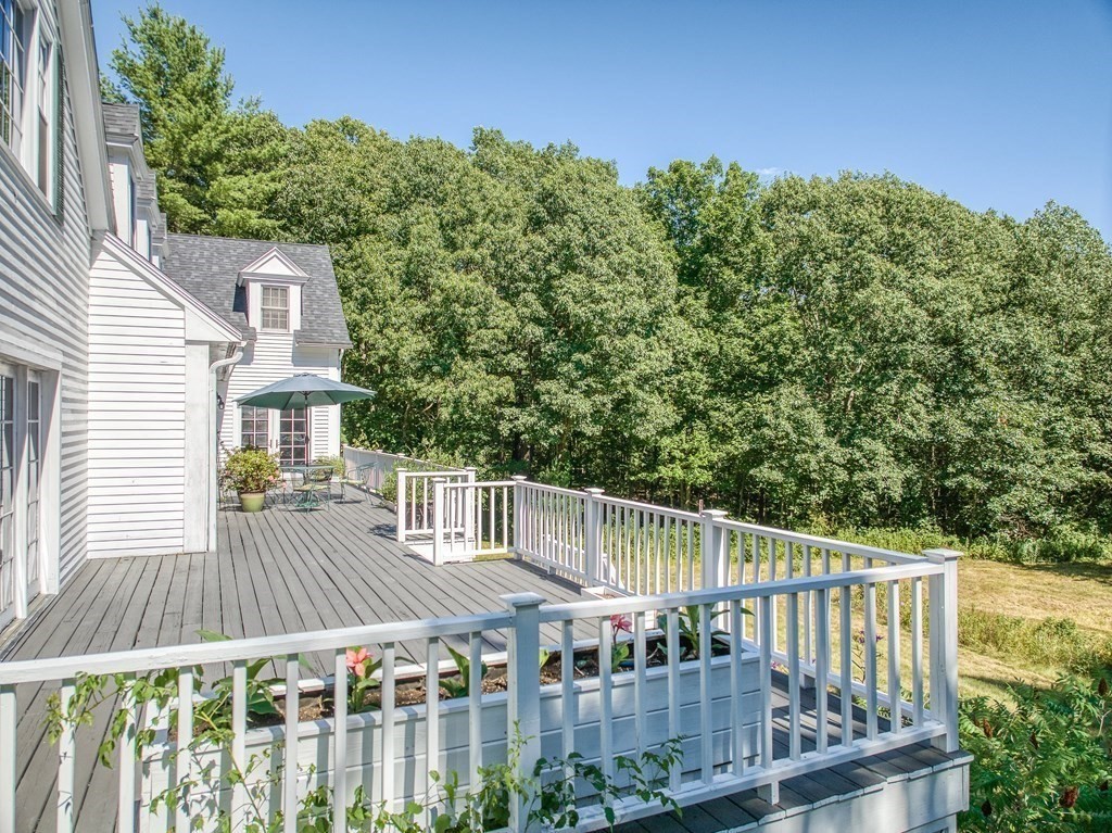 163 Still River Road Harvard, MA 01451 - Photo 5 of 42 a view of a wooden deck and a yard