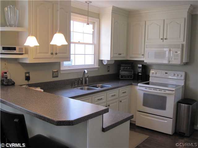 9279 Drawbridge Road Mechanicsville, VA 23116 - Photo 5 of 14 a kitchen with stainless steel appliances granite countertop a sink a stove and white cabinets