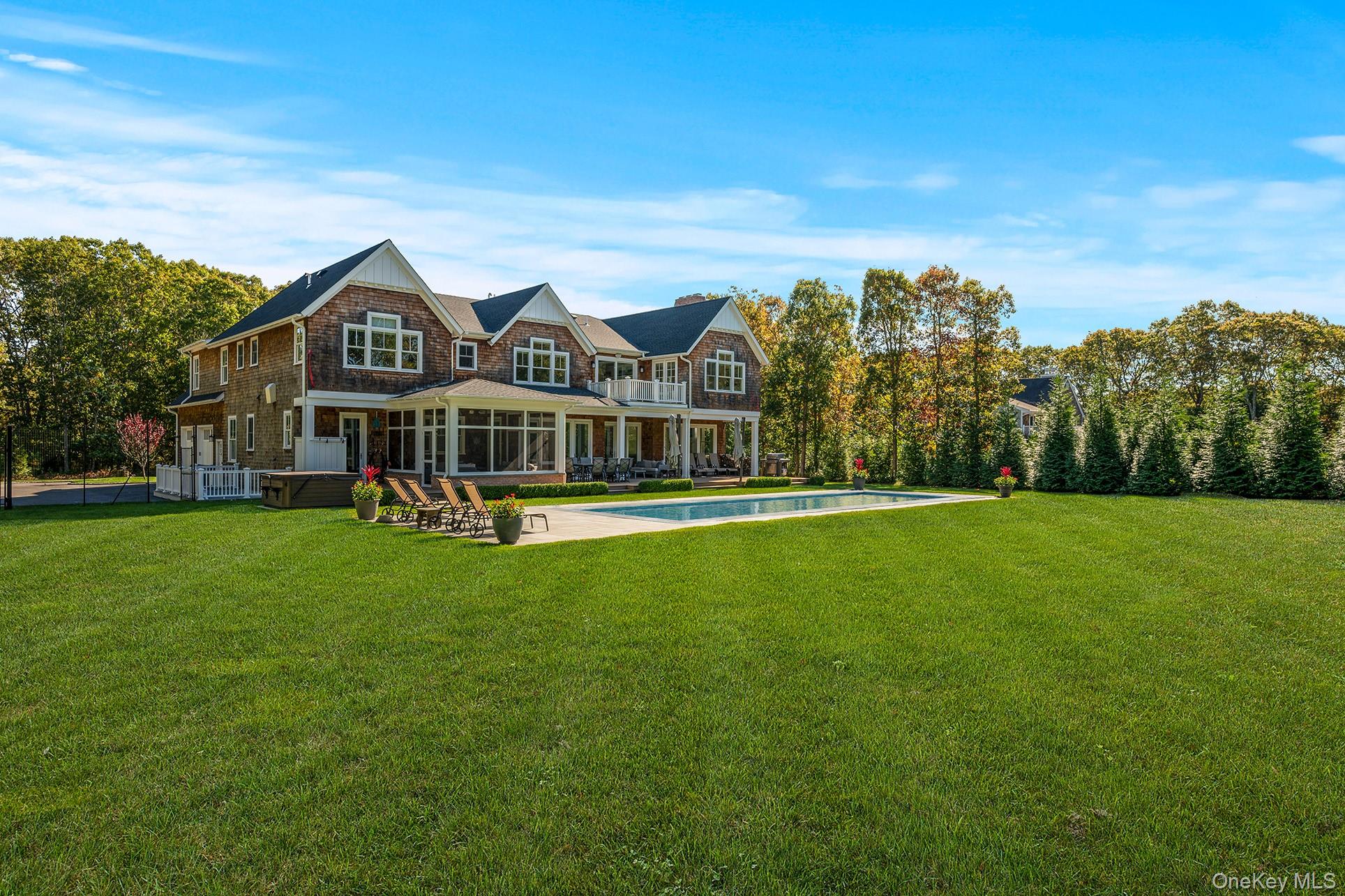 41 Arbutus Road Quogue, NY 11959 - Photo 6 of 35 a front view of a house with a yard