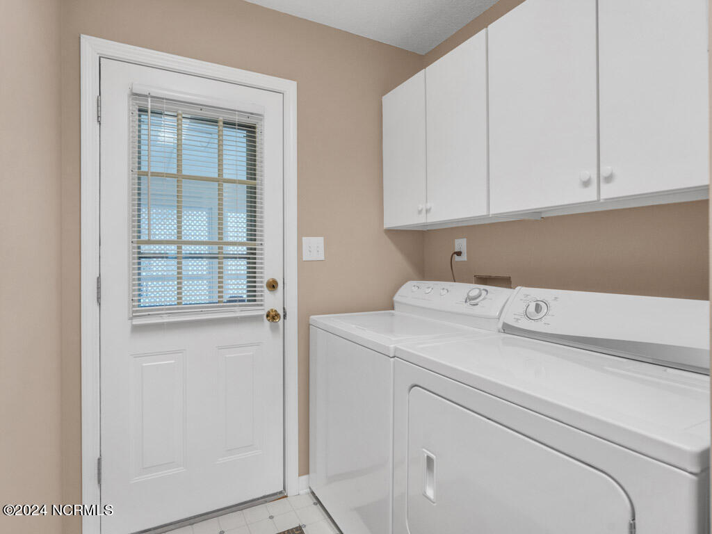 417 Deer Path Calabash, NC 28467 - Photo 17 of 32 There are extra cabinets over the washer and dryer that will convey. A well-equipped laundry space streamlines the washing process, allowing you to save time and energy. The washer and dryer are included, and the laundry area offers easy access from the carport.