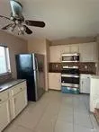 a kitchen with stainless steel appliances a sink and a refrigerator