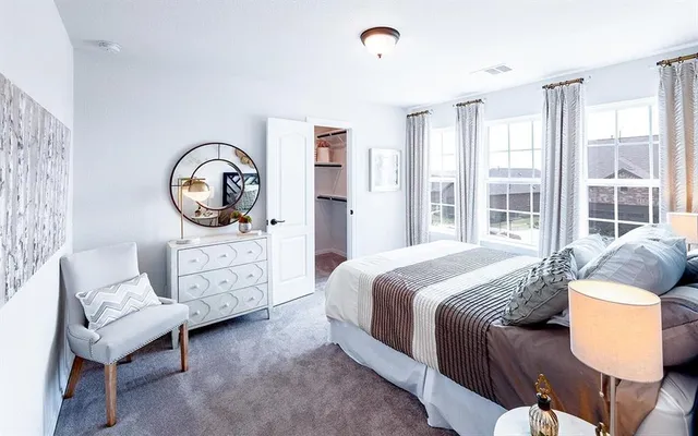 a bedroom with bed and a window