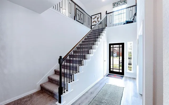 a view of entryway and hall with wooden floor