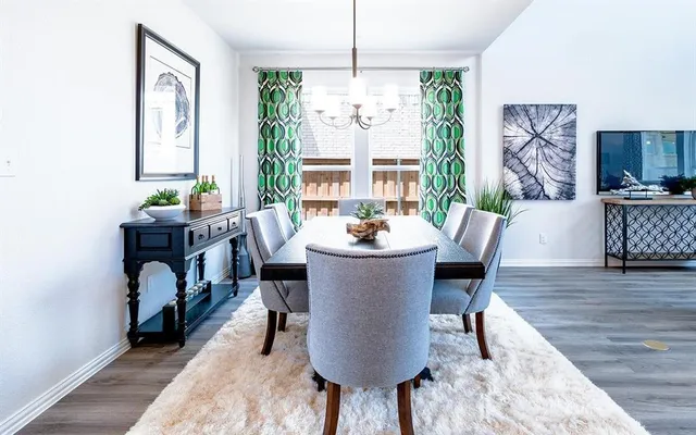 a dining room with furniture window and wooden floor
