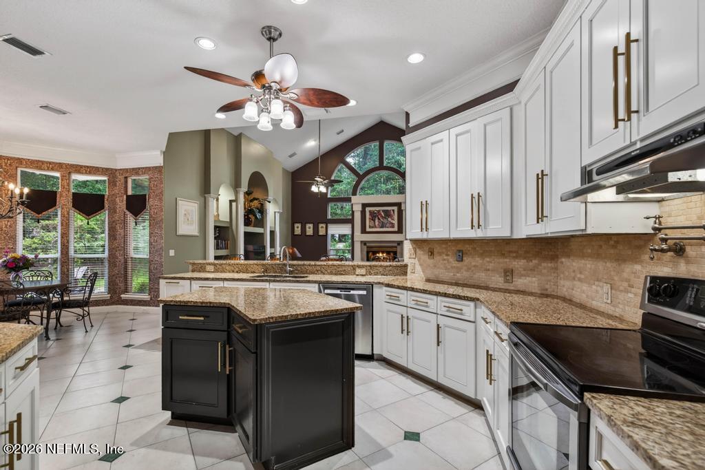 1483 Bridgette Way Fleming Island, FL 32003 - Photo 15 of 63 a kitchen with stainless steel appliances granite countertop a stove and a sink