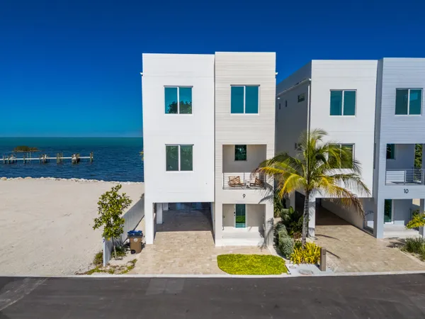 a view of open kitchen with a table and chairs