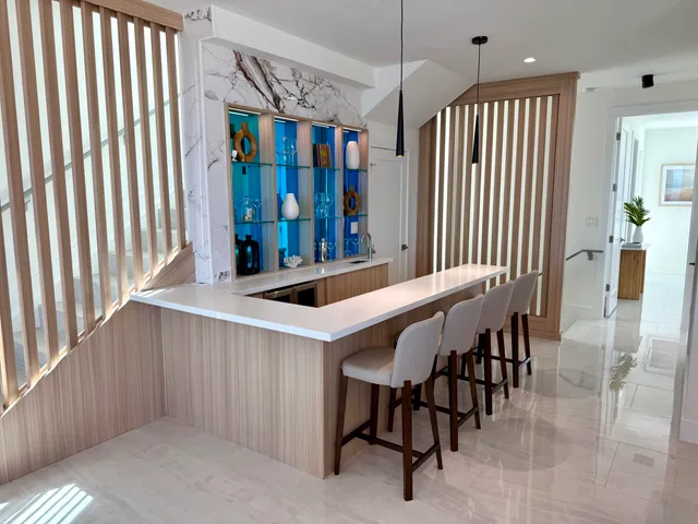 a kitchen with kitchen island a stove a table and chairs in it