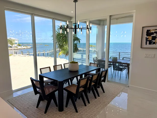 a living room with furniture and a dining table with wooden floor