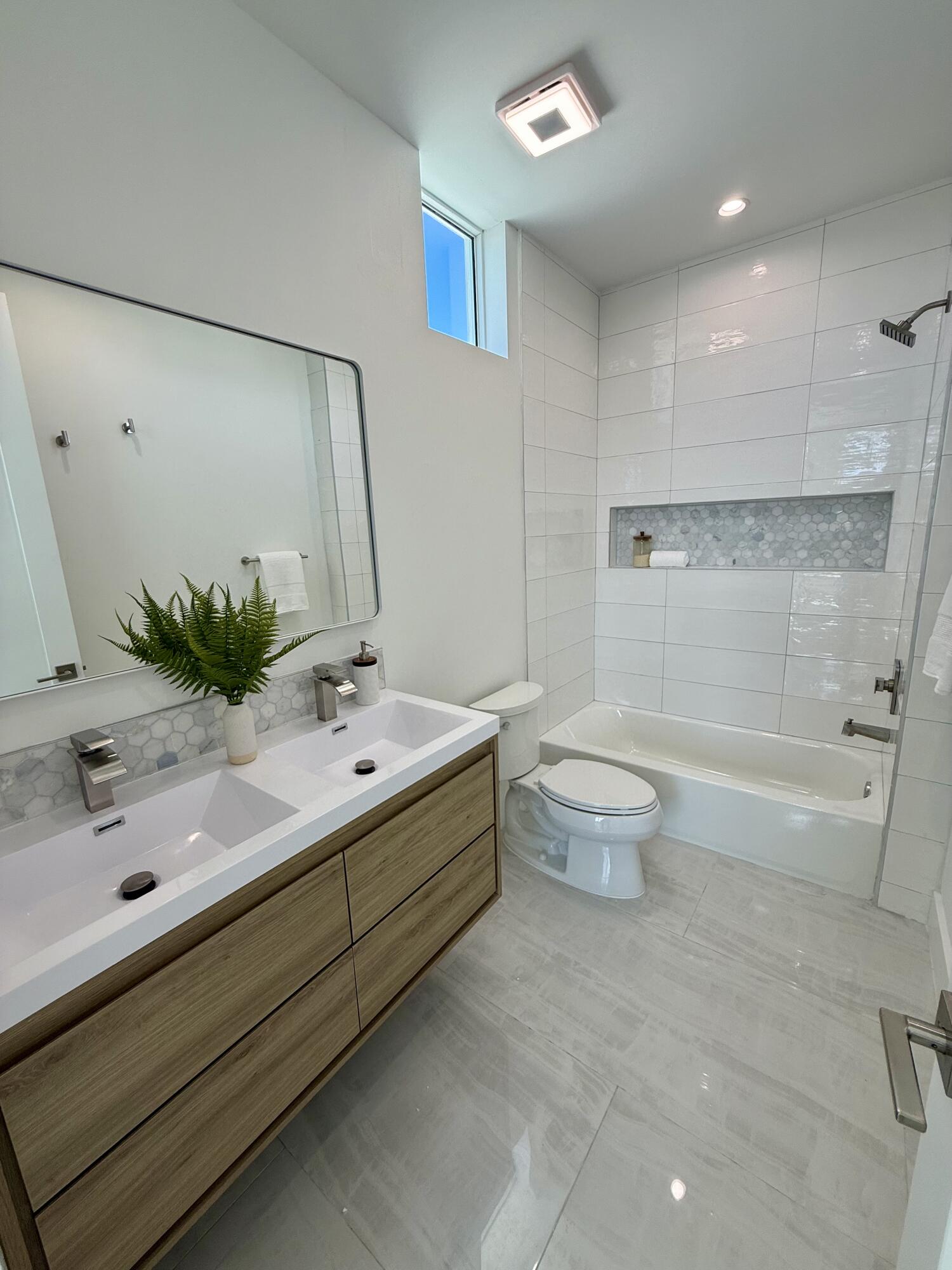 990 41st Street, Unit 9 Marathon, FL 33050 - Photo 27 of 52 a bathroom with a double vanity sink toilet and shower