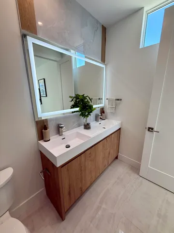 a bedroom with a bed and a mirror