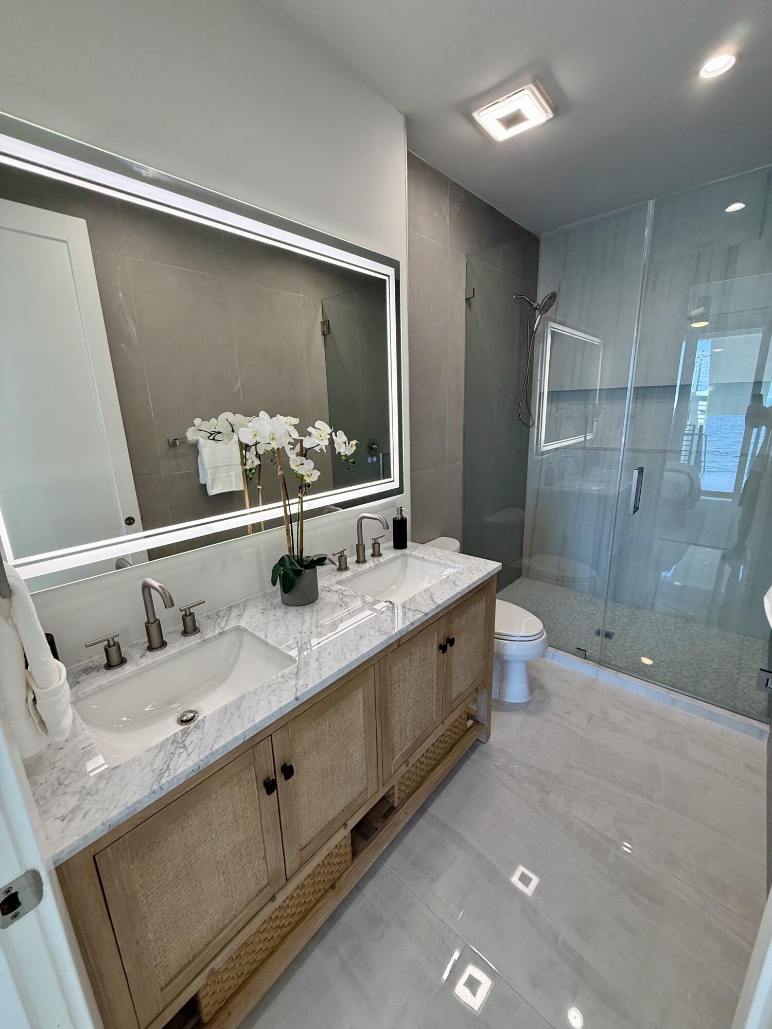 990 41st Street, Unit 9 Marathon, FL 33050 - Photo 34 of 52 a bathroom with a double vanity sink mirror double and shower