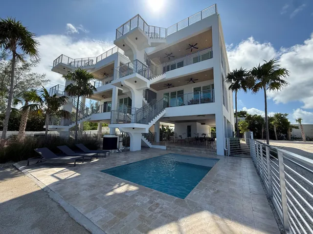 a view of a balcony with wooden floor and outdoor seating