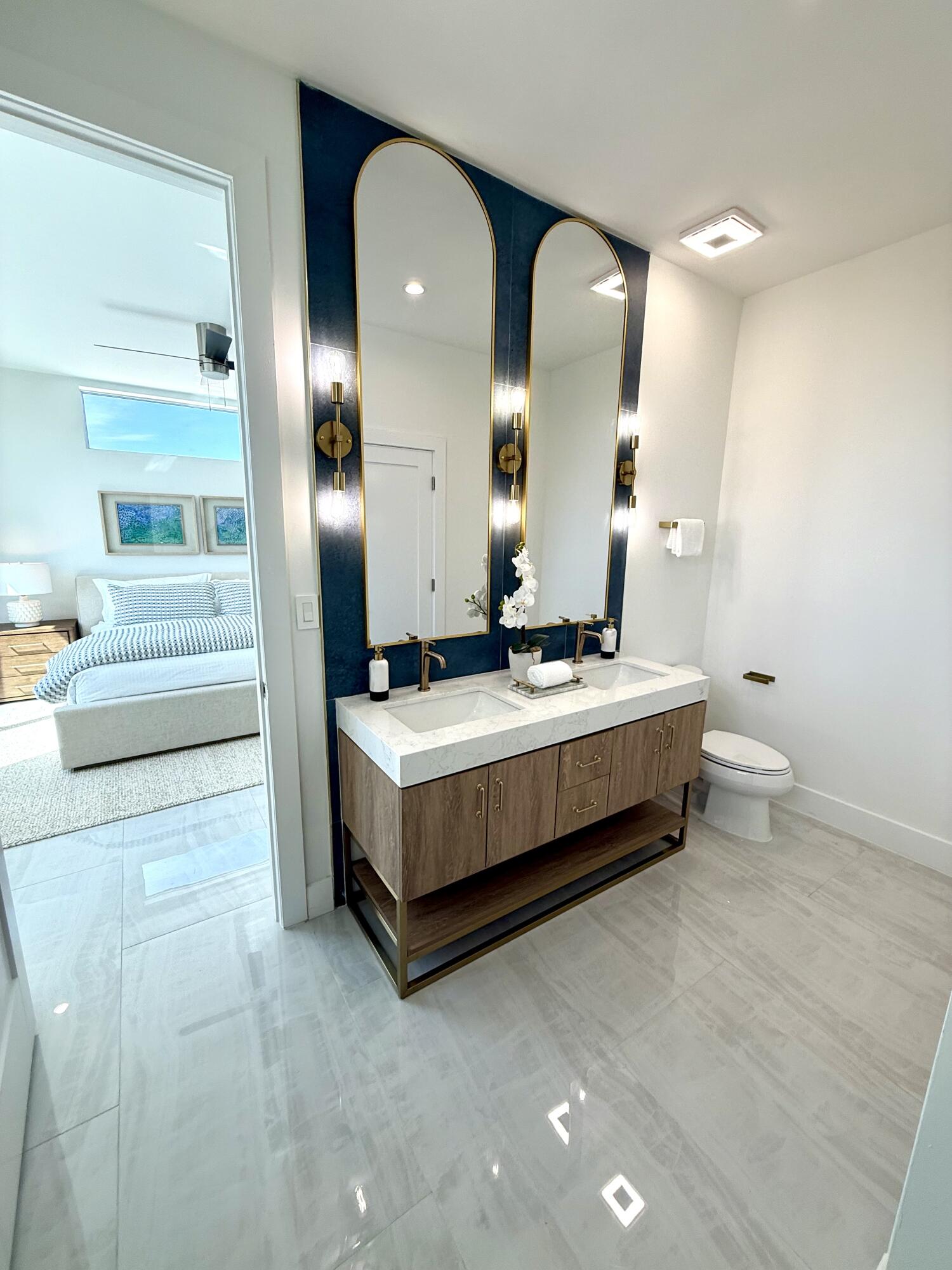 990 41st Street, Unit 9 Marathon, FL 33050 - Photo 9 of 52 a spacious bathroom with a double vanity sink and a mirror