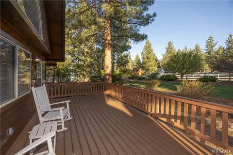 a view of balcony with wooden floor and seating space