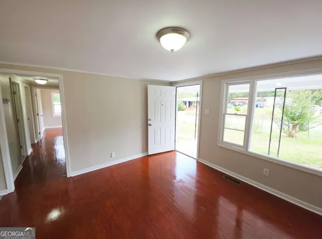 wooden floor in an empty room with a window