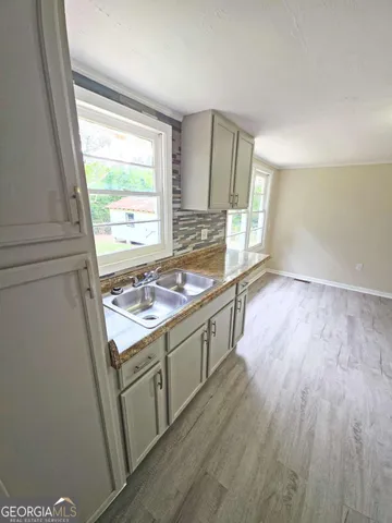 a room with wooden floor and window