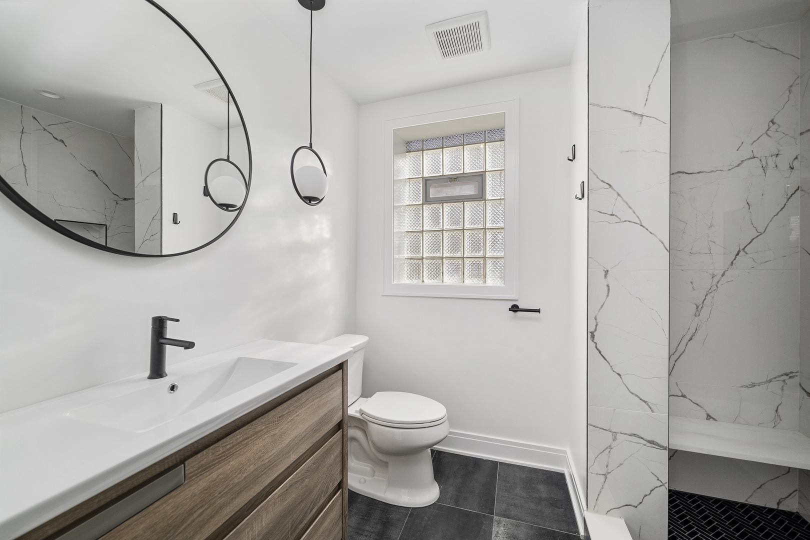 6747 Riverside Drive Berwyn, IL 60402 - Photo 19 of 32 a bathroom with a sink a toilet and a mirror