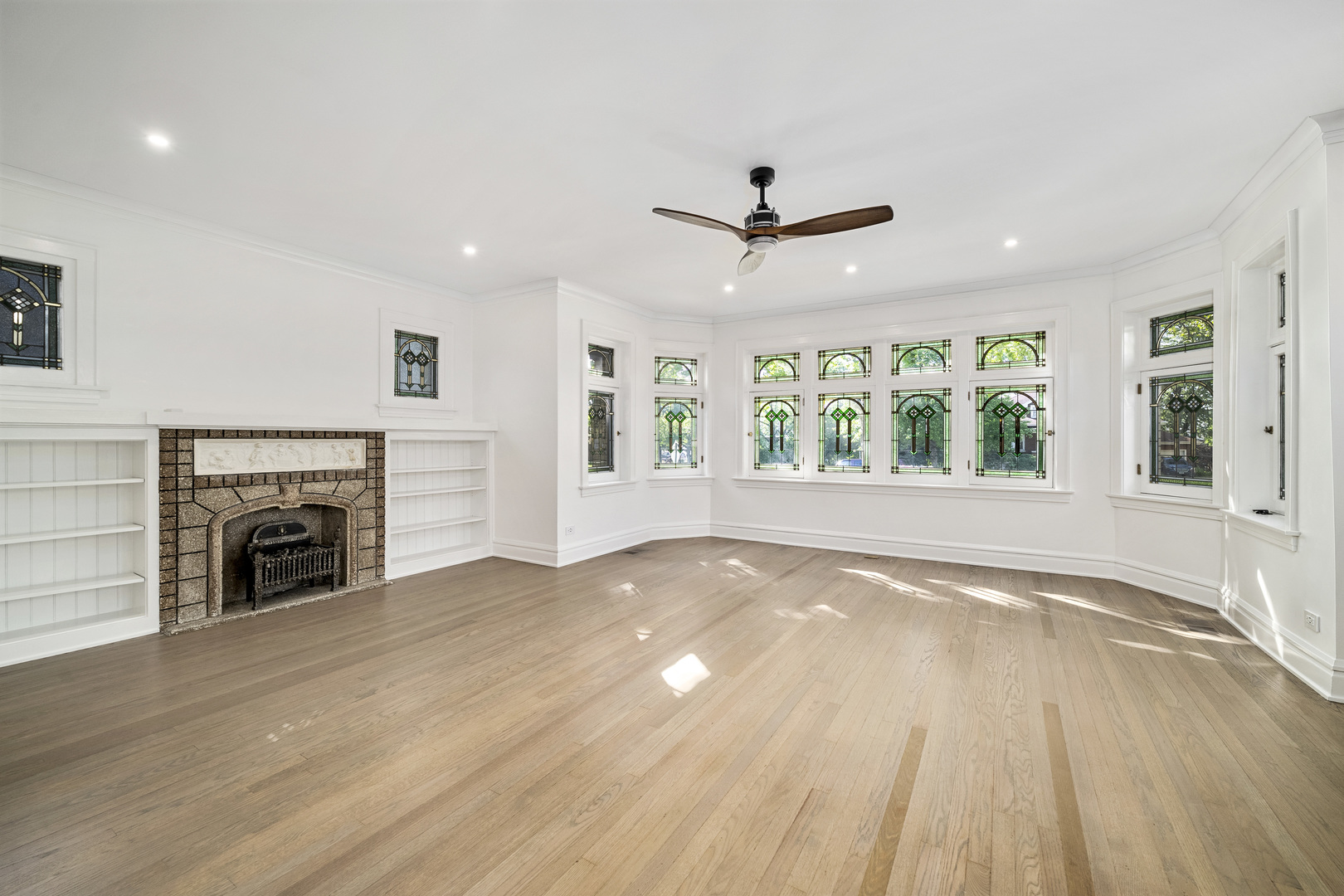 6747 Riverside Drive Berwyn, IL 60402 - Photo 5 of 32 a view of an empty room with a fireplace and a window