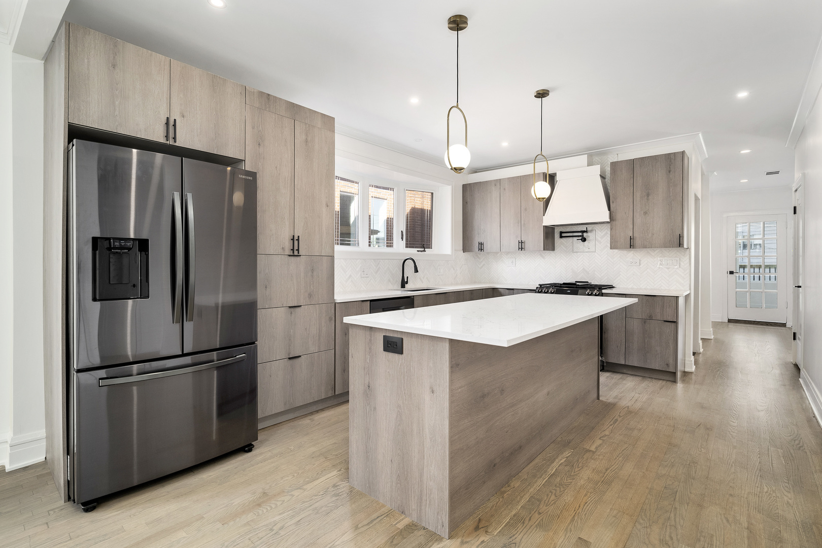 6747 Riverside Drive Berwyn, IL 60402 - Photo 8 of 32 a kitchen with kitchen island white cabinets and stainless steel appliances