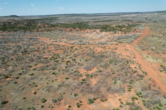 a view of a field with a mountain in the background