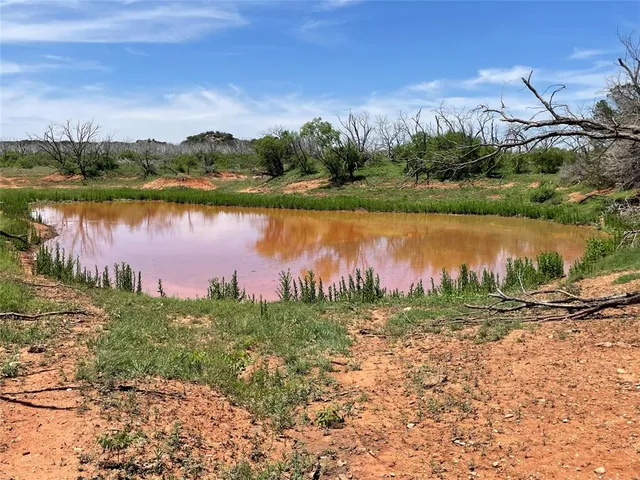 a view of a lake with houses in the back