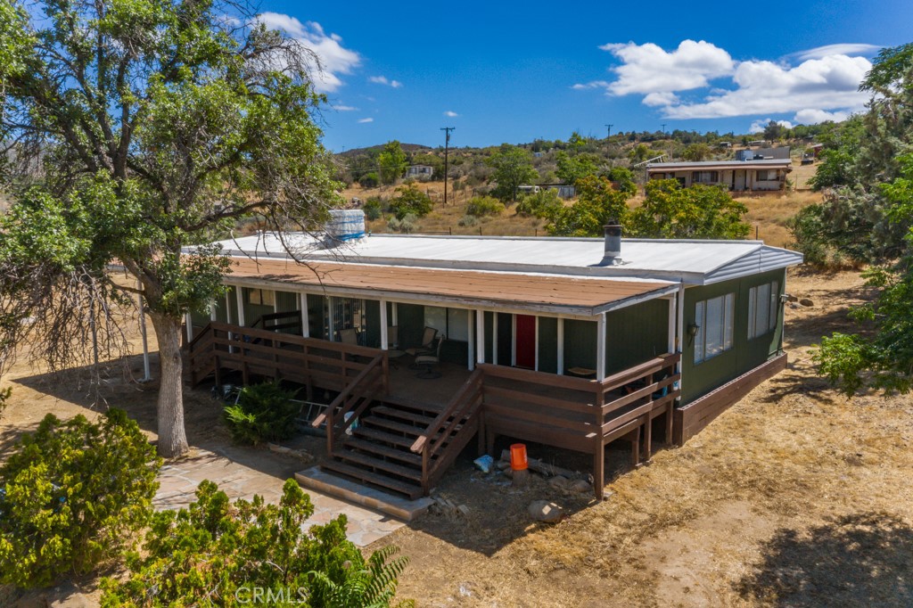 58771 Yaw Road Anza, CA 92539 - Photo 1 of 1 a view of a house with wooden deck and a yard
