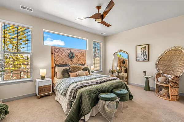 a bedroom with a large bed and a mirror