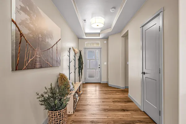 a view of a hallway with wooden floor and stairs