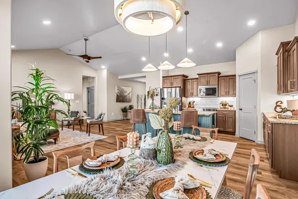 a kitchen with granite countertop stainless steel appliances a sink a refrigerator and cabinets