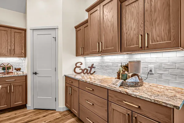 a kitchen with granite countertop kitchen island stainless steel appliances a sink stove and refrigerator