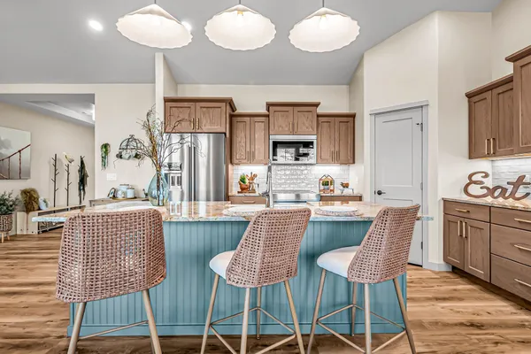 a living room with furniture wooden floor and a large window