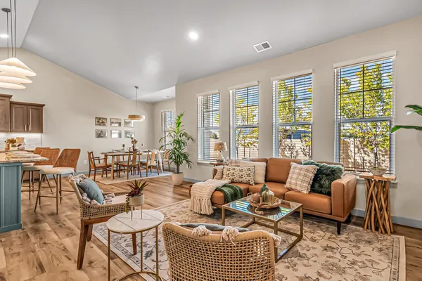 a living room with furniture kitchen and a chandelier