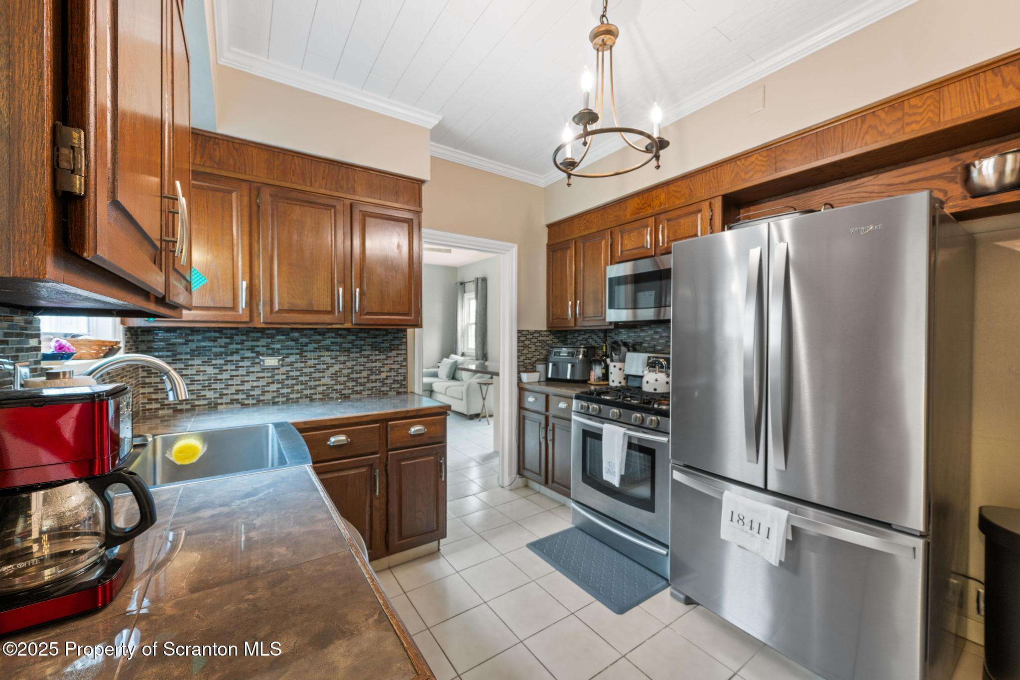 114 Spring Street Clarks Green, PA 18411 - Photo 17 of 47 a kitchen with stainless steel appliances granite countertop a refrigerator a stove and a sink