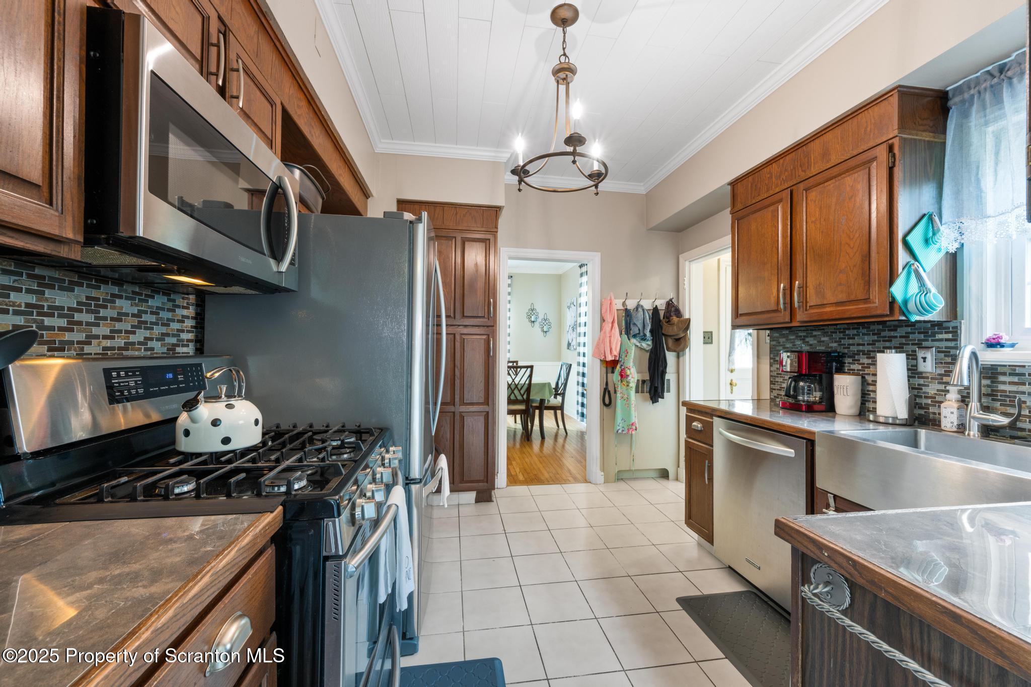 114 Spring Street Clarks Green, PA 18411 - Photo 18 of 47 a kitchen with stainless steel appliances granite countertop a stove refrigerator and cabinets