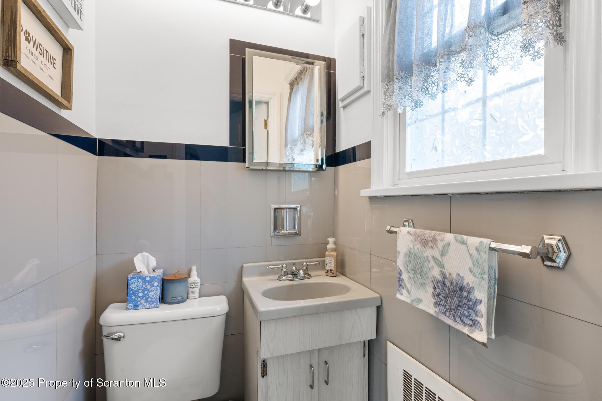 114 Spring Street Clarks Green, PA 18411 - Photo 22 of 47 a bathroom with a sink a toilet and a mirror