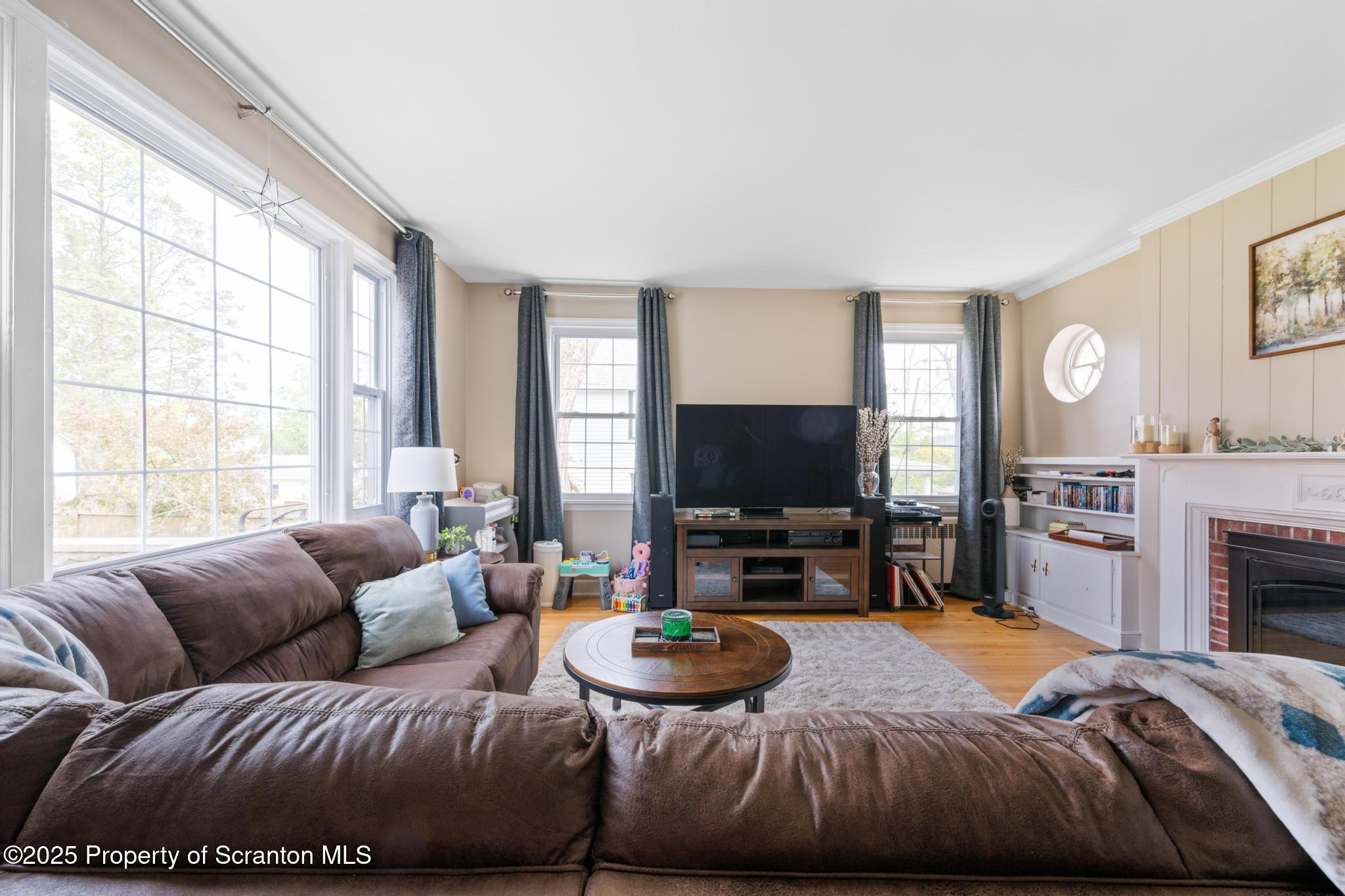 114 Spring Street Clarks Green, PA 18411 - Photo 4 of 47 a living room with furniture a fireplace and a flat screen tv