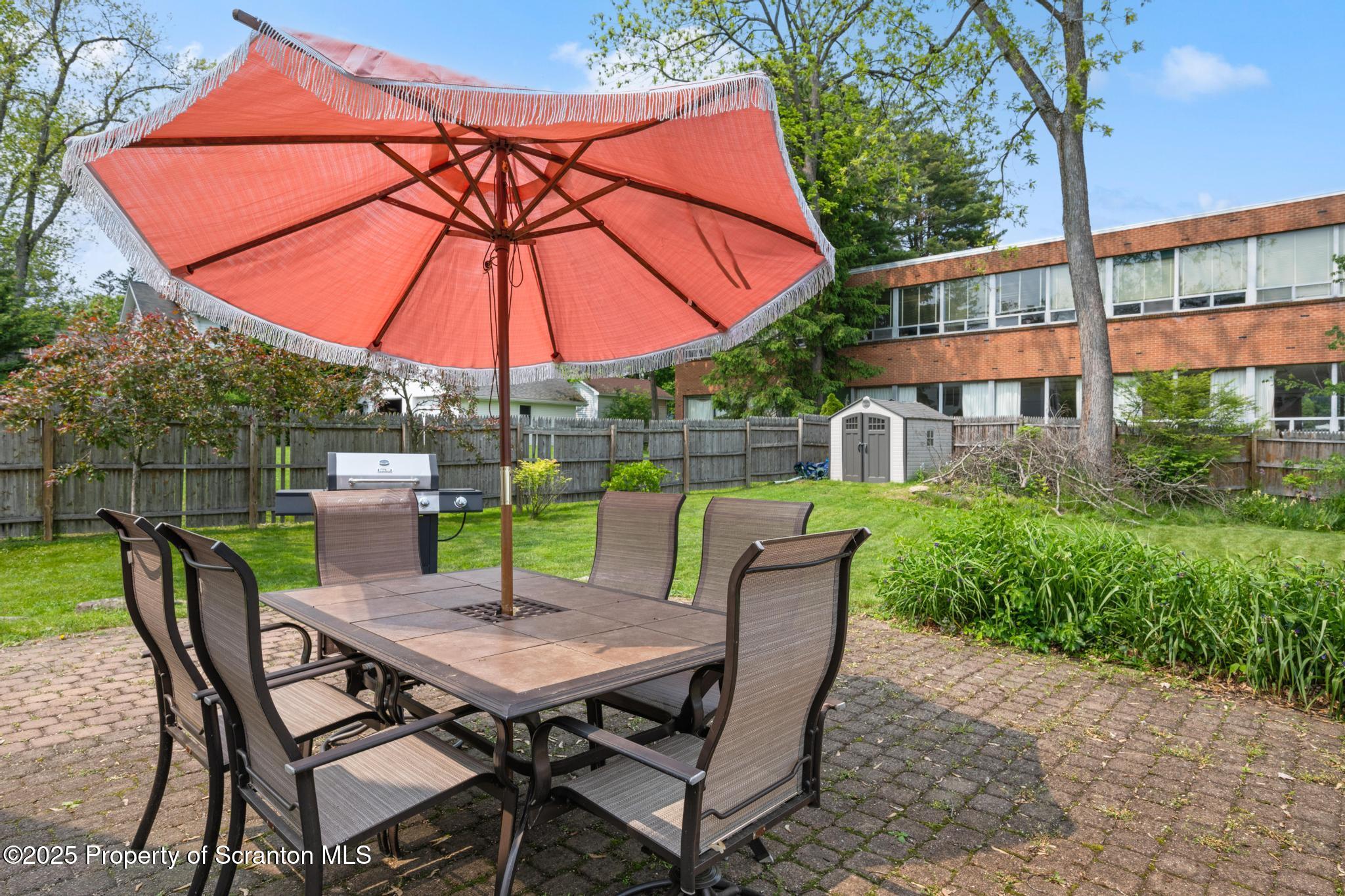 114 Spring Street Clarks Green, PA 18411 - Photo 41 of 47 a view of a patio with a table chairs and a umbrella